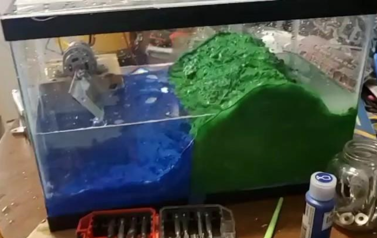 Tank with blue water and green hill