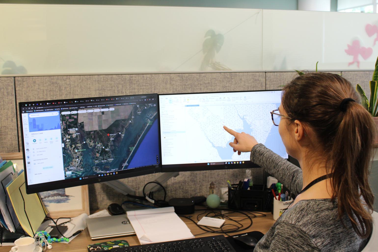 Allman pointing at GIS map on computer monitor