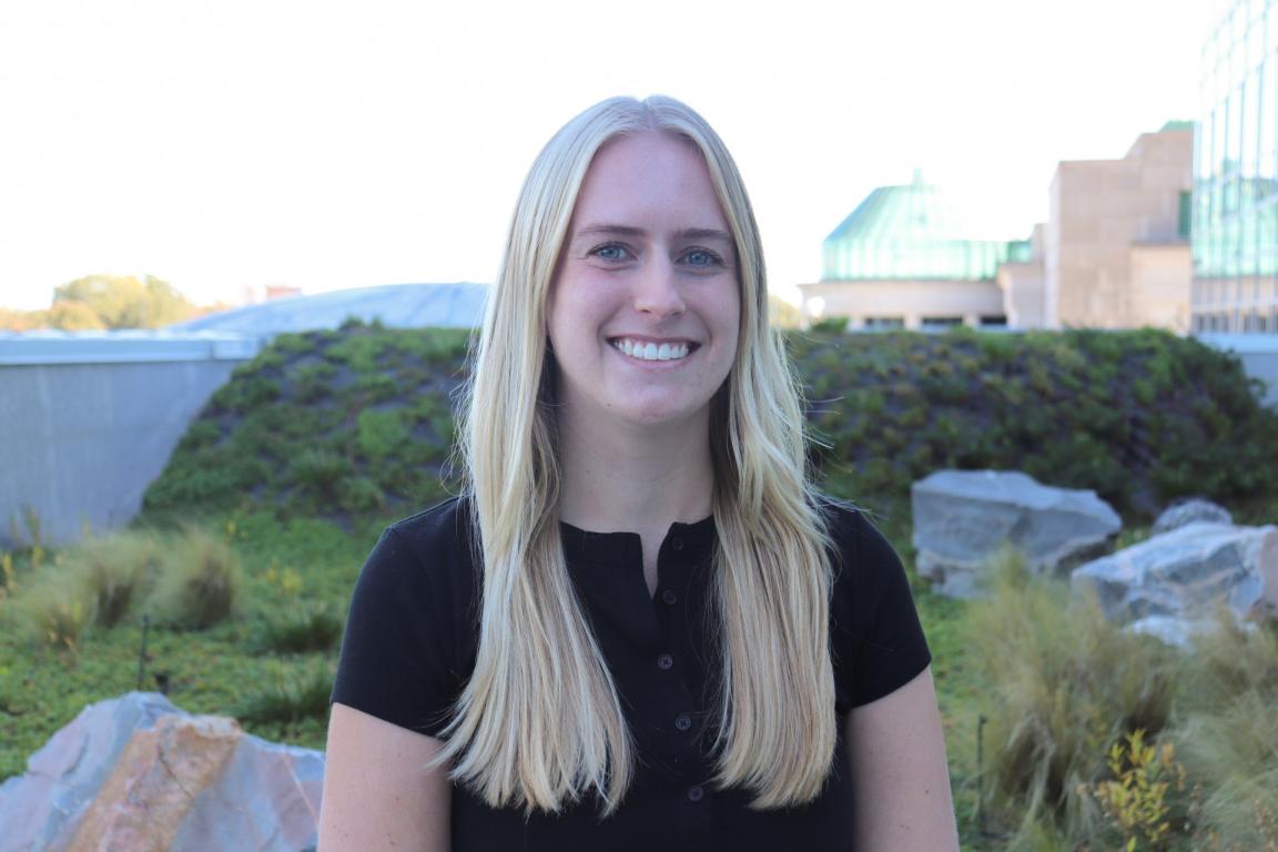 Riley Ragain on roof with plants