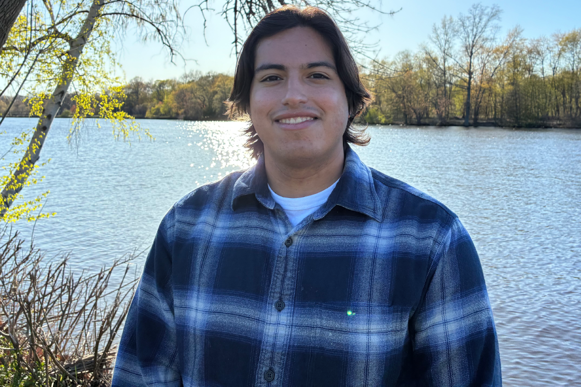 Giancarlo Richardson smiling in front of a body of water