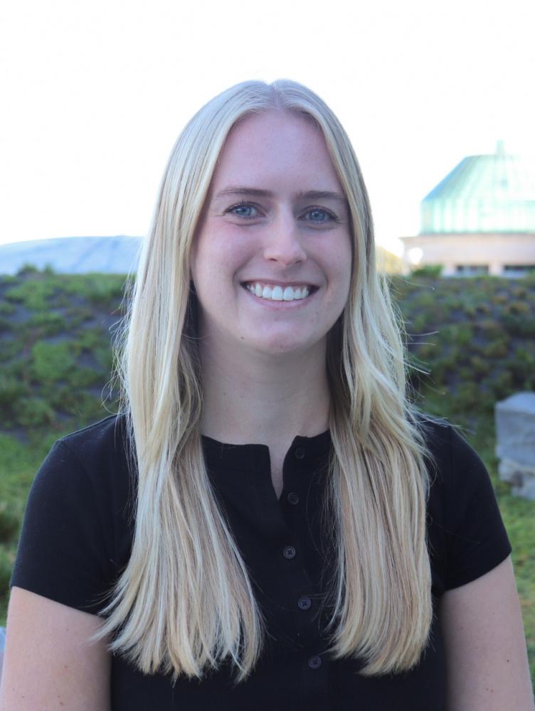 Riley Ragain on roof with plants