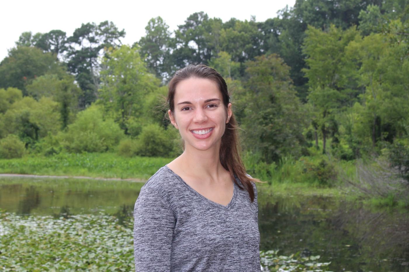 Allman smiling with pond and greenery in the background