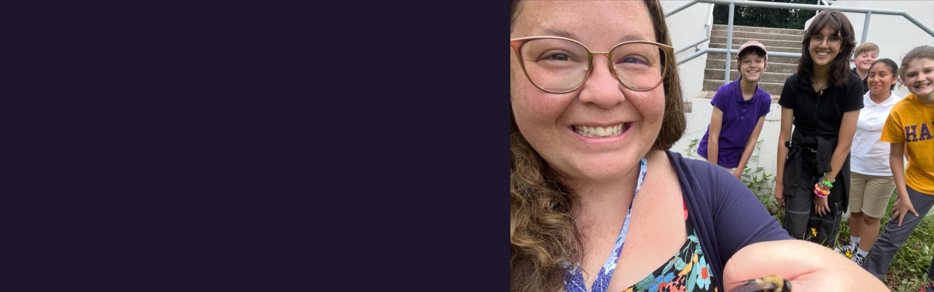 Desirae Balsamo holding a bee students in background