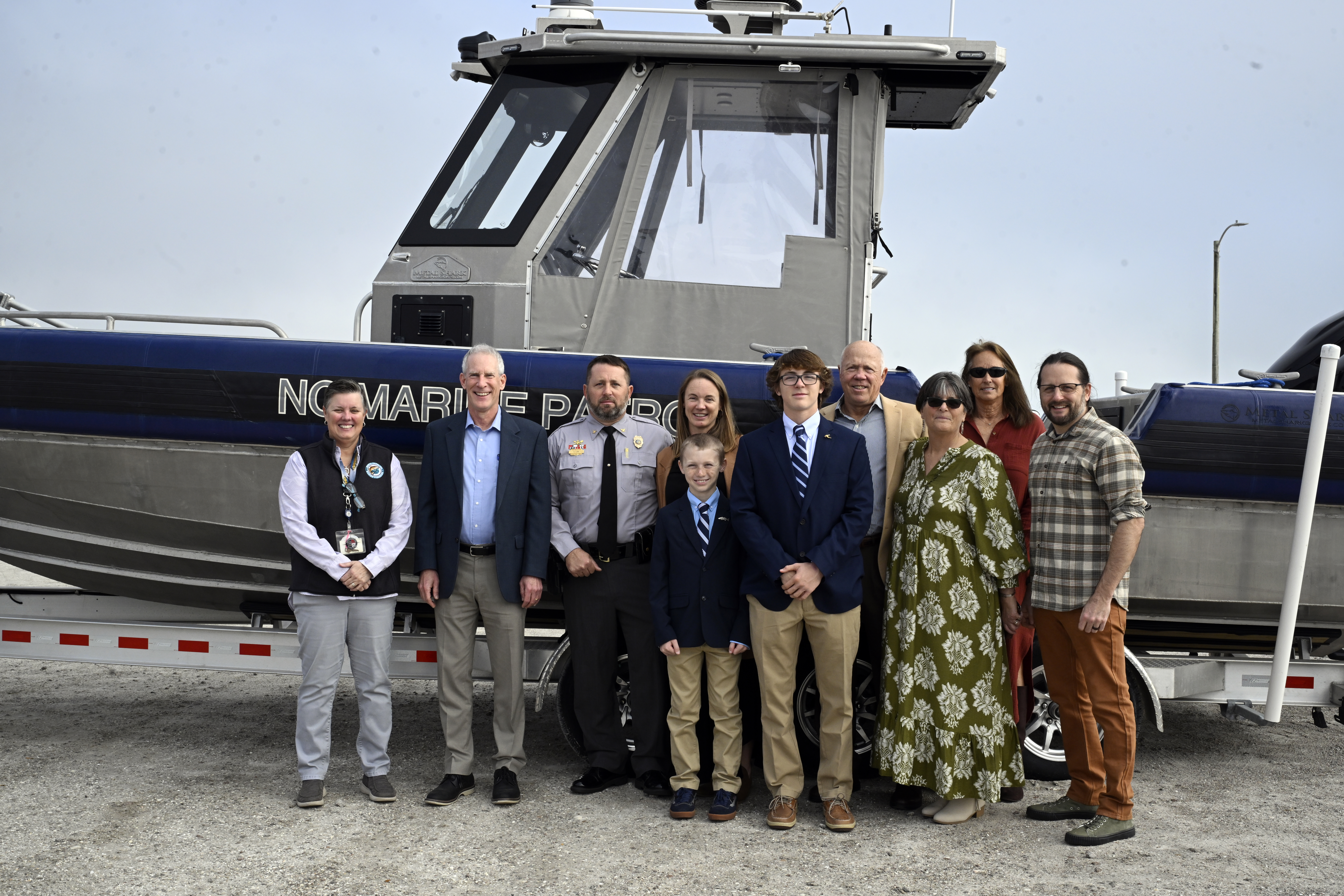 Chris Lee family photo including Secretary Reid Wilson and Director Kat Rawls