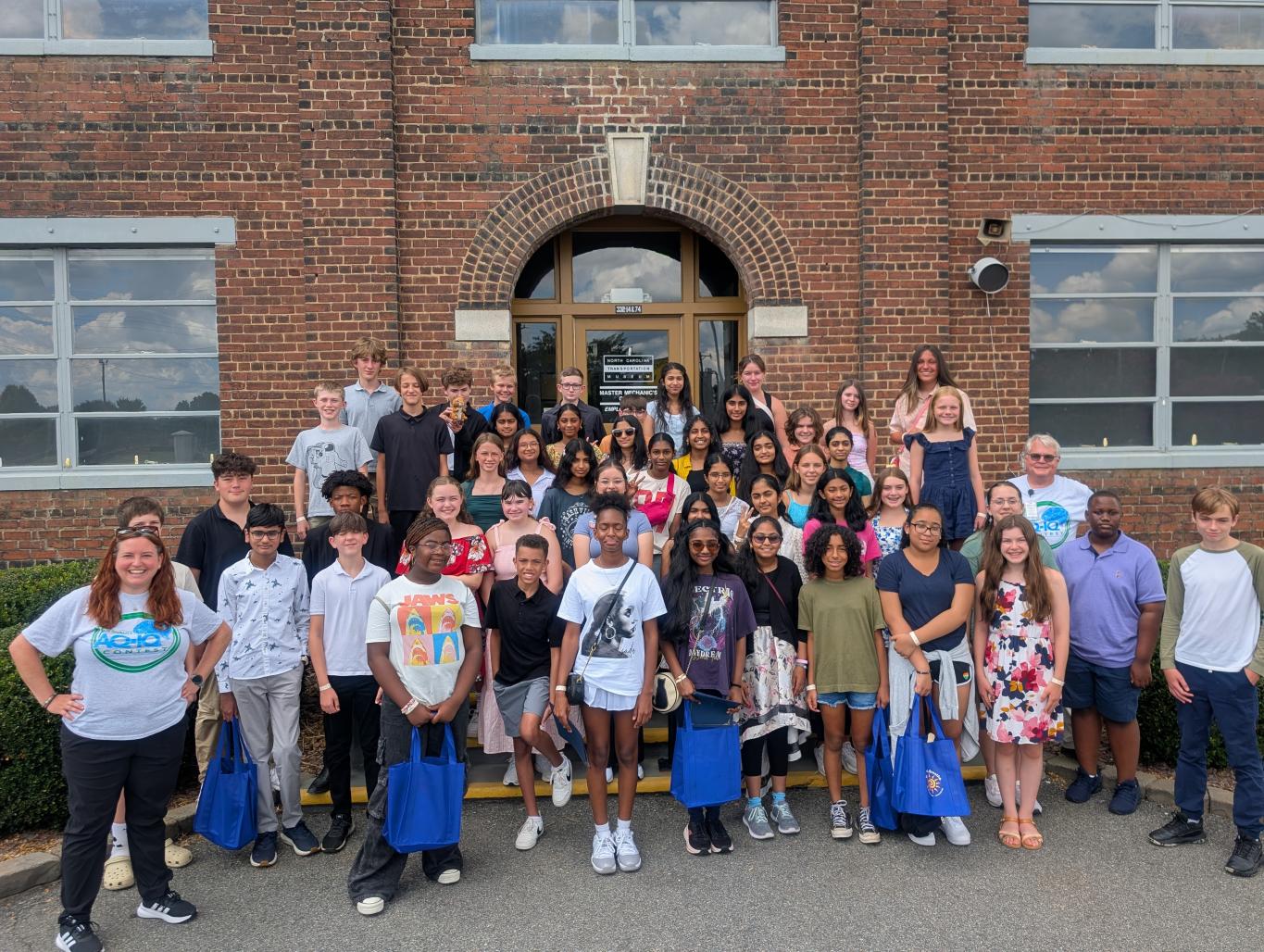 Students pose for a group photo with DEQ staff at a past AQ-IQ award ceremony
