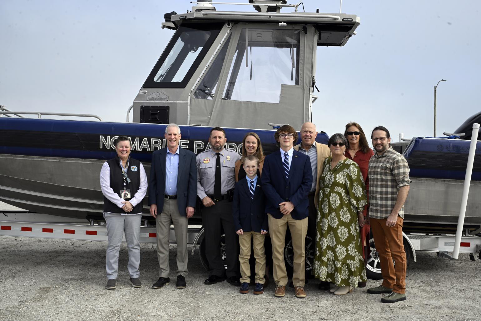 Chris Lee family photo including Secretary Reid Wilson and Director Kat Rawls