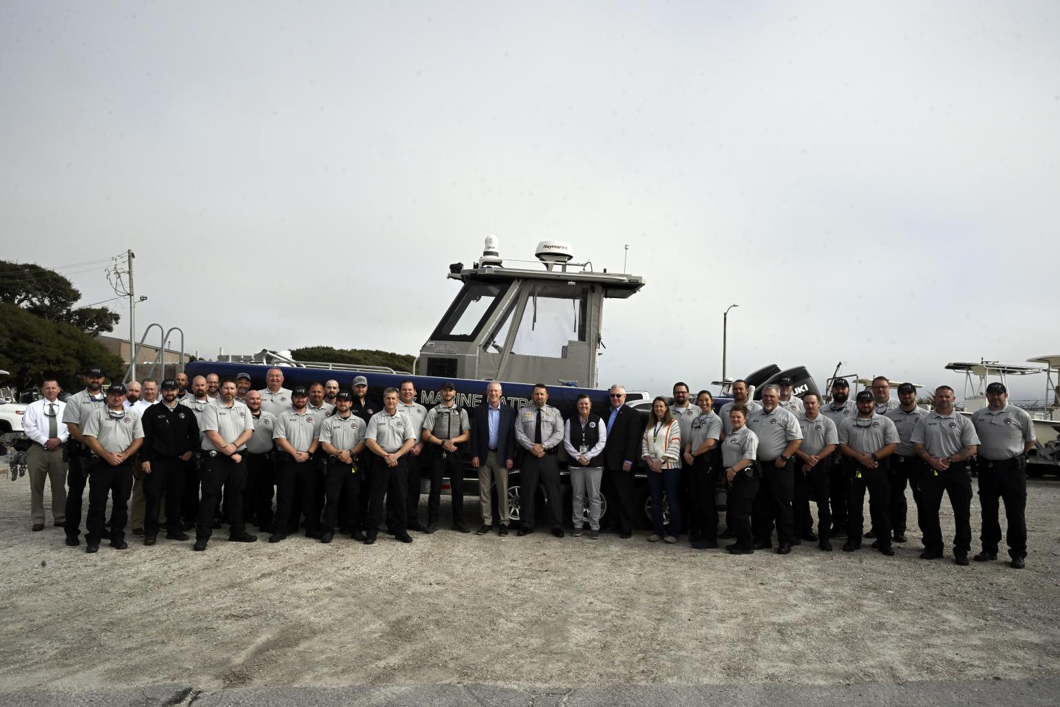 Large group photo of Marine Patrol with Secretary Reid Wilson and Kathy Rawls
