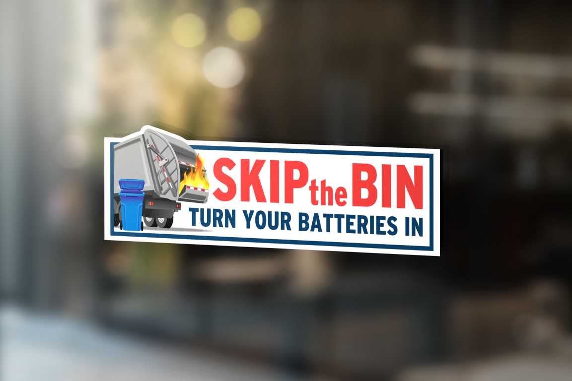 Mockup of sticker on a window stating "Skip the Bin; Turn Your Batteries In"