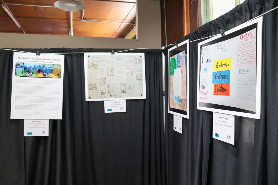 Student-made posters hang in display.