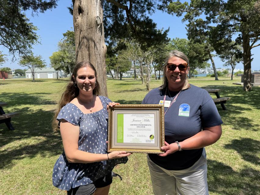 Janina Millis presented with her environmental education certificate by Lori Davis