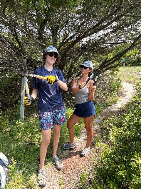 Two people pruning trails