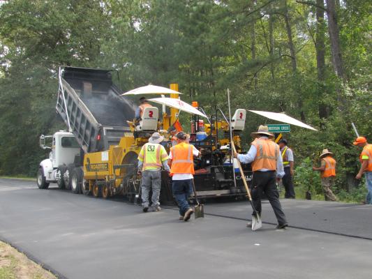 Big truck with people with workers in orange vests