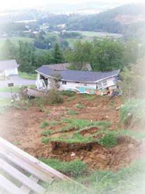 A home destroyed by a landslide related to Hurricane Frances