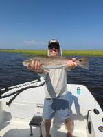 Josh Whibley holds up a red drum