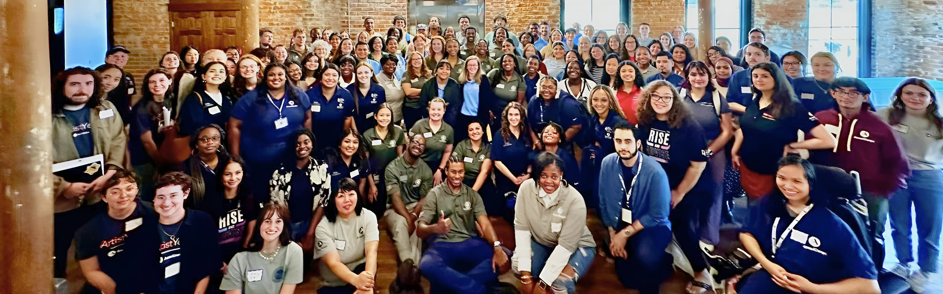 a large group of americorps volunteers gathered for a picture