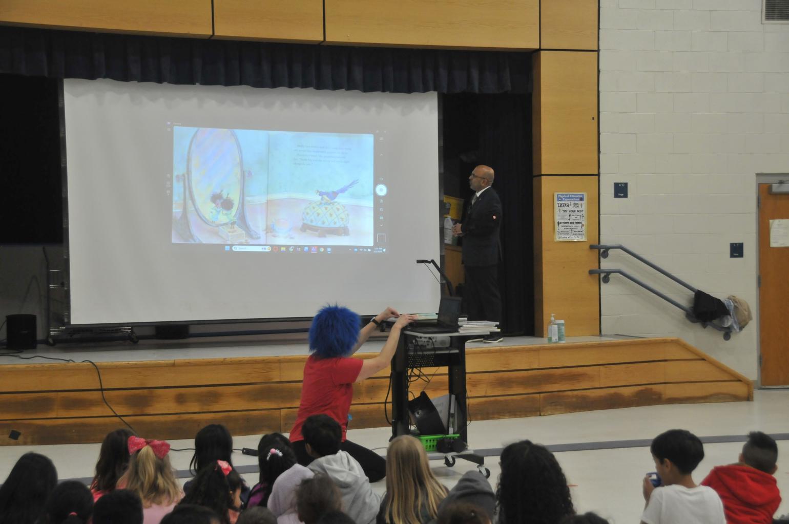 Secretary Sangvai reading to students.
