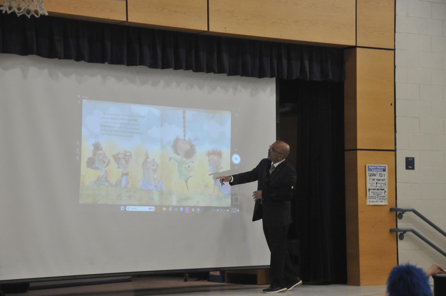 Secretary Sangvai reading to students.