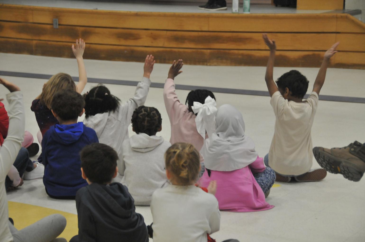 Secretary Sangvai reading to students.