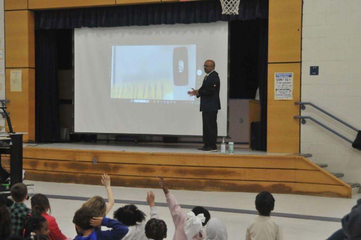 Secretary Sangvai reading to students.