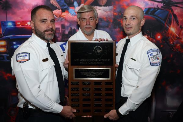 NCDHHS OEMS Chief Tom Mitchell presents Surry County EMS the championship plaque