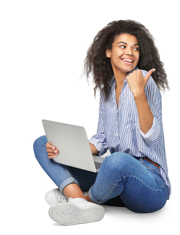 Woman sitting crisscrossed on floor motions over her shoulder with thumb