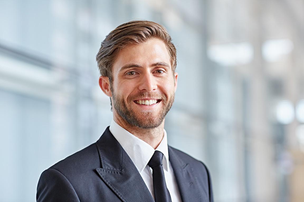 Man in suit, in modern office building