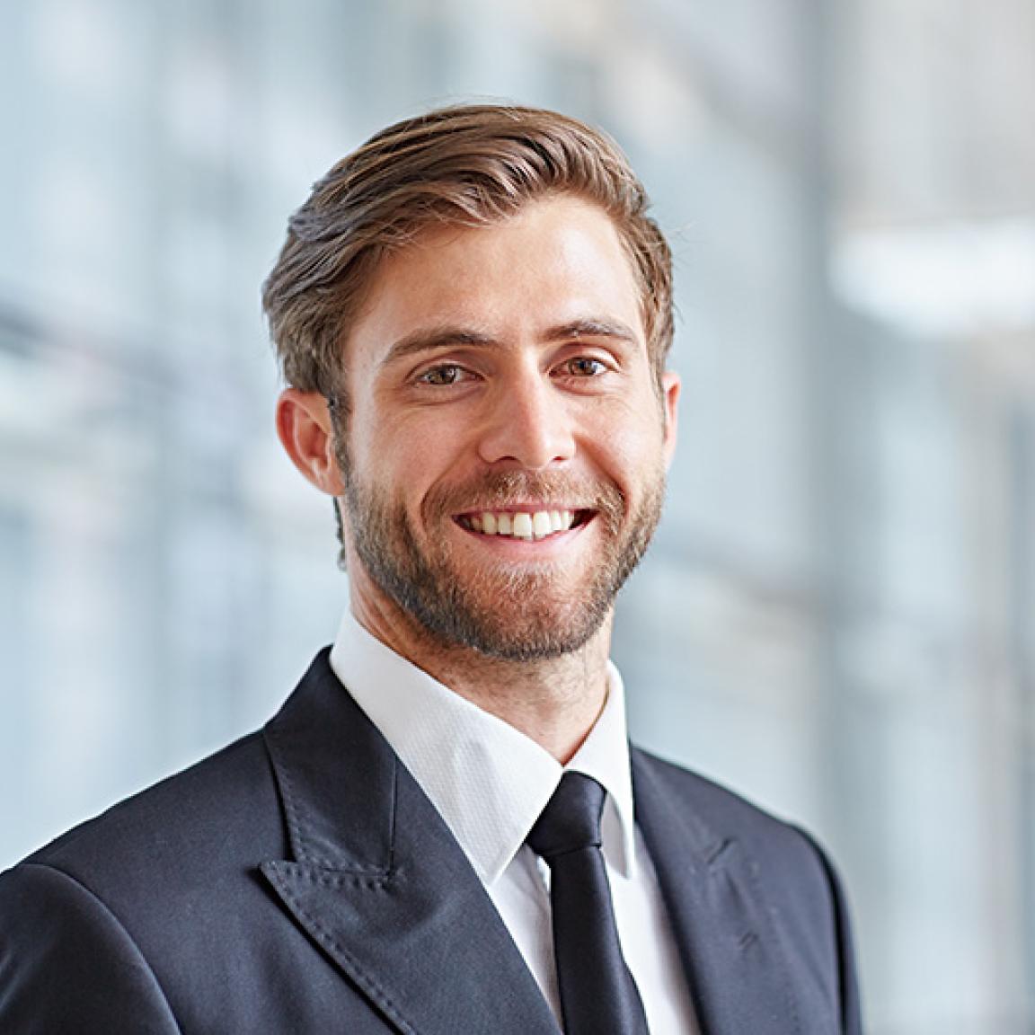 Man in suit, in modern office building