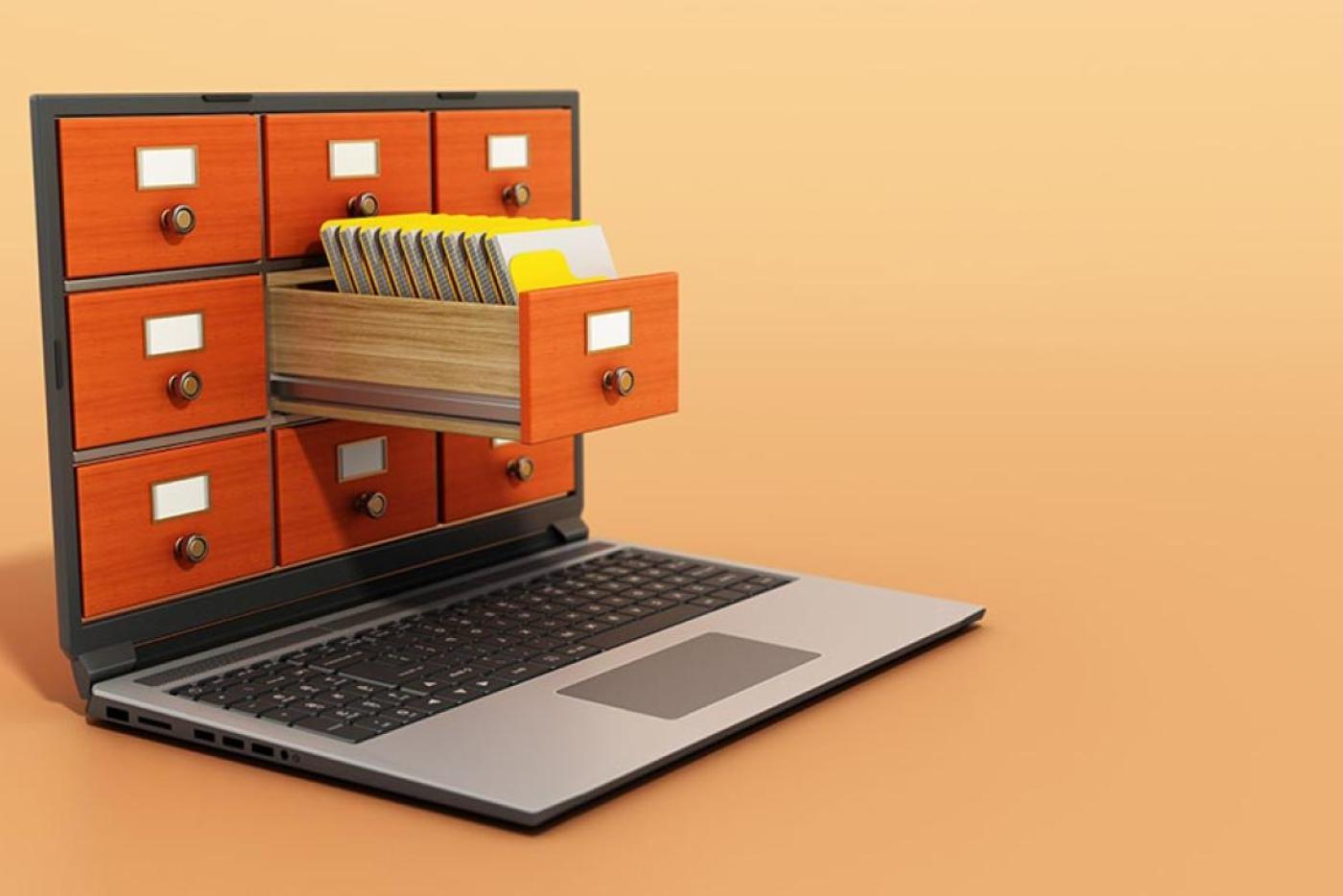 A modern laptop screen displays an old fashioned card catalog with a drawer emerging from the screen.