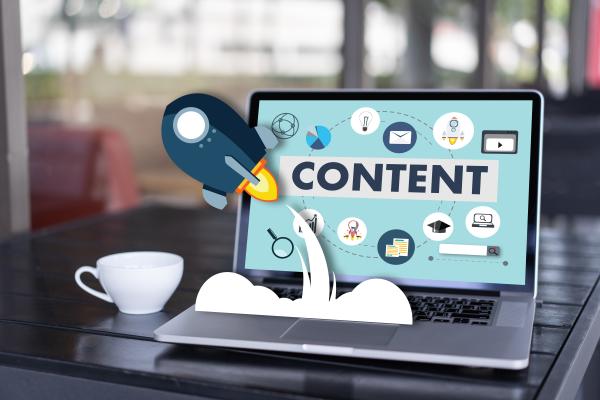 Rocket ship that starts from the computer screen that has word "content"
