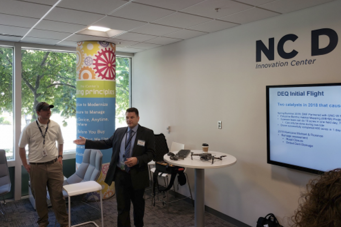 men presenting at TV screen