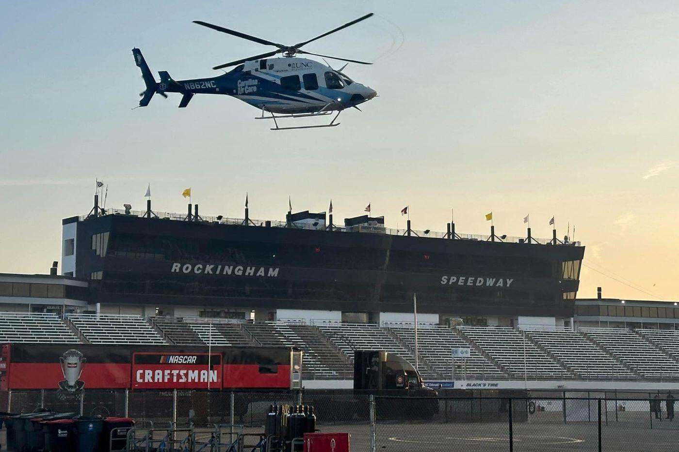 A helicopter flying above the Rockingham Speedway sign