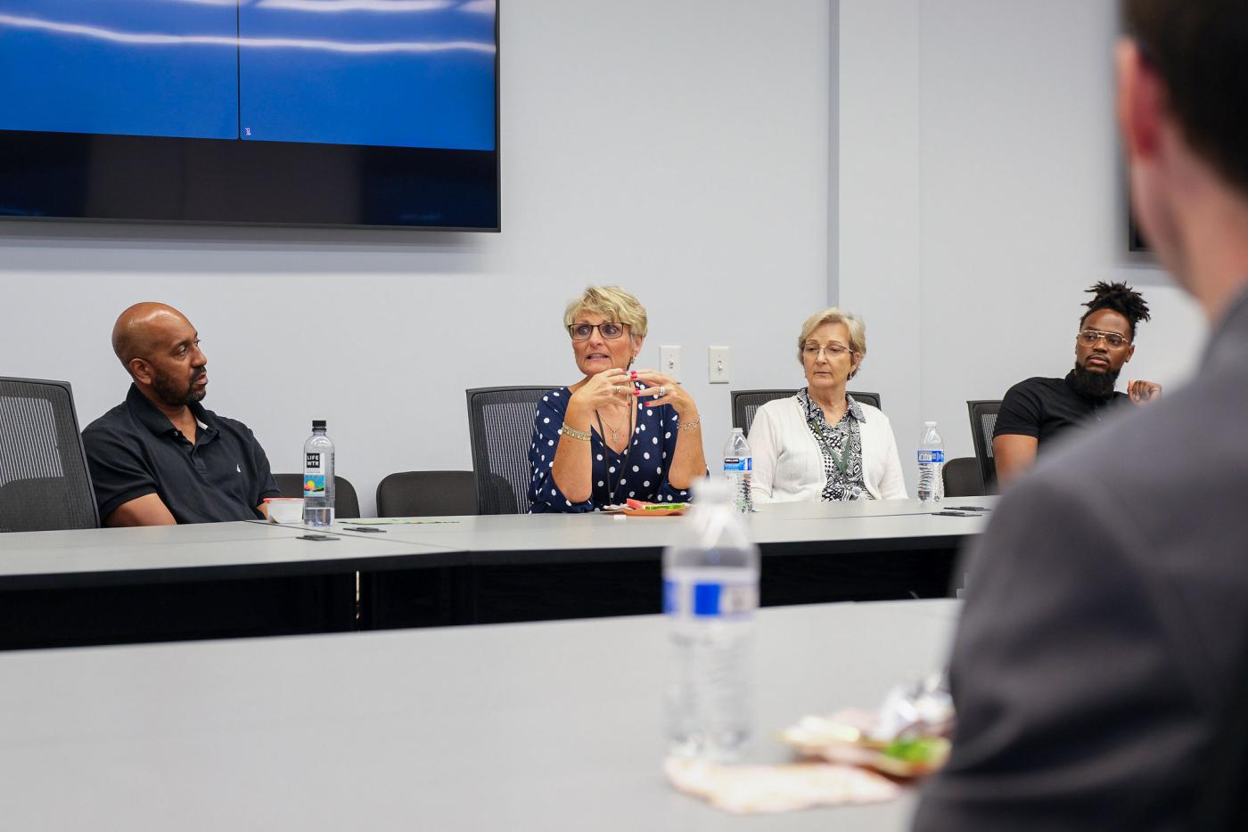 Group of NCDIT members sitting at a conference room table.