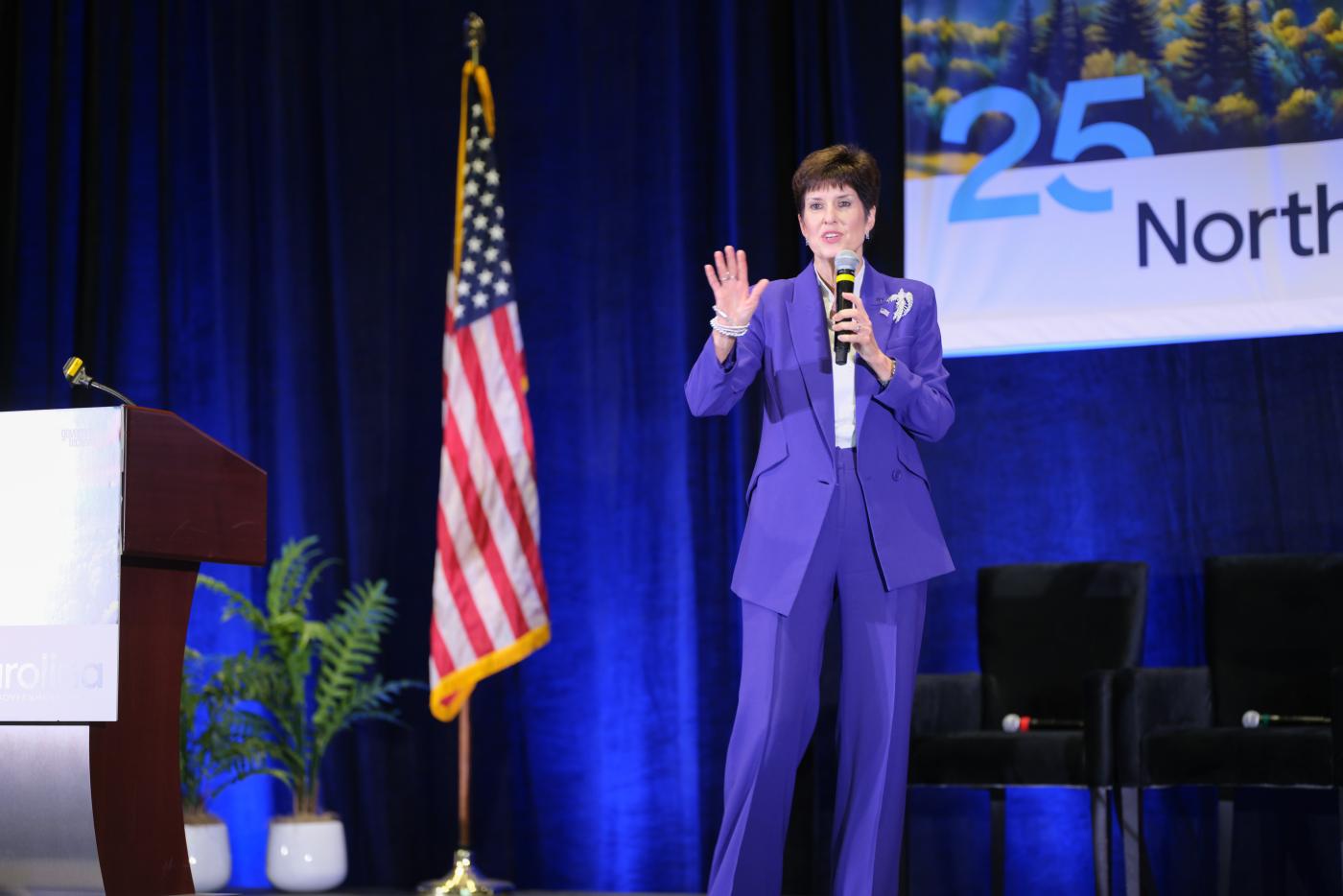 Secretary Teena Piccione speaking on stage