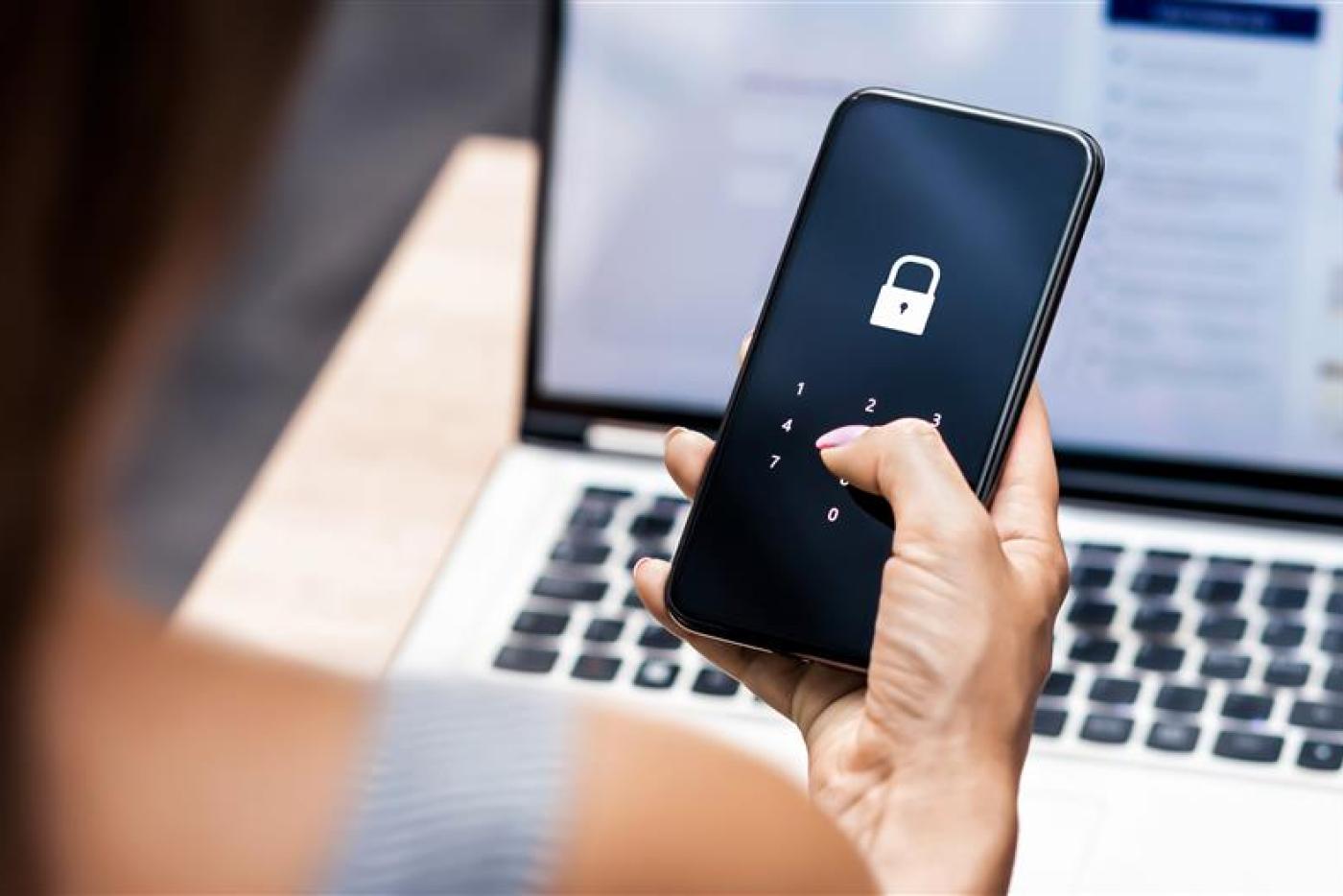 Person entering password on cellphone