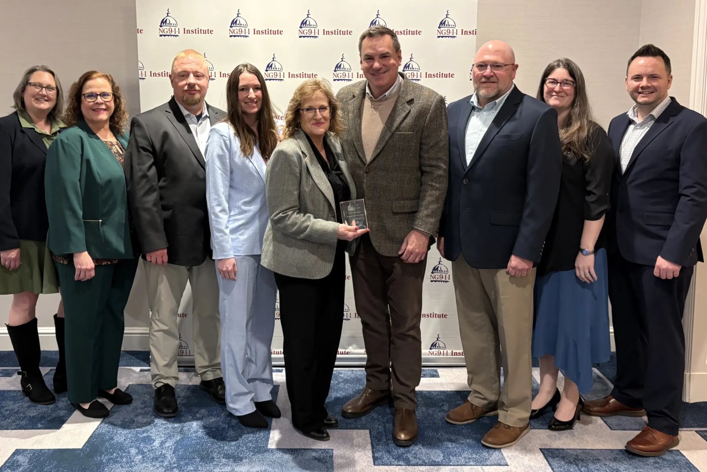 N.C. 911 Board Executive Director Pokey Harris and N.C. 911 Board staff accept the NG911 Awareness Award from the NG9-1-1 Institute.