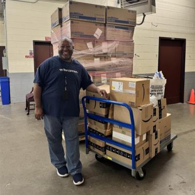 Maurice Durham with boxed up school supplies