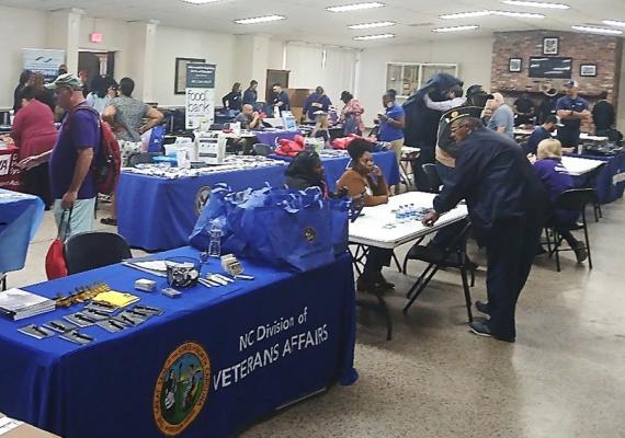 Tables hold food and clothing donations for vets