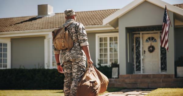 Veteran standing in front of house.