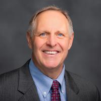 Headshot of Tim Gabel in a suit and tie.