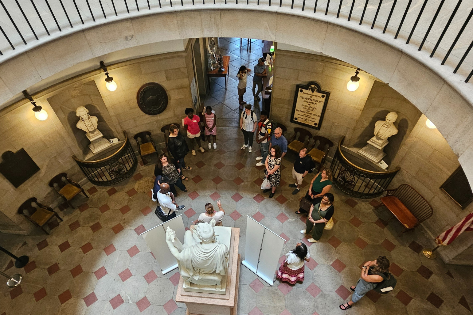 Teachers gather around the George Washington Statue in the State Capitol