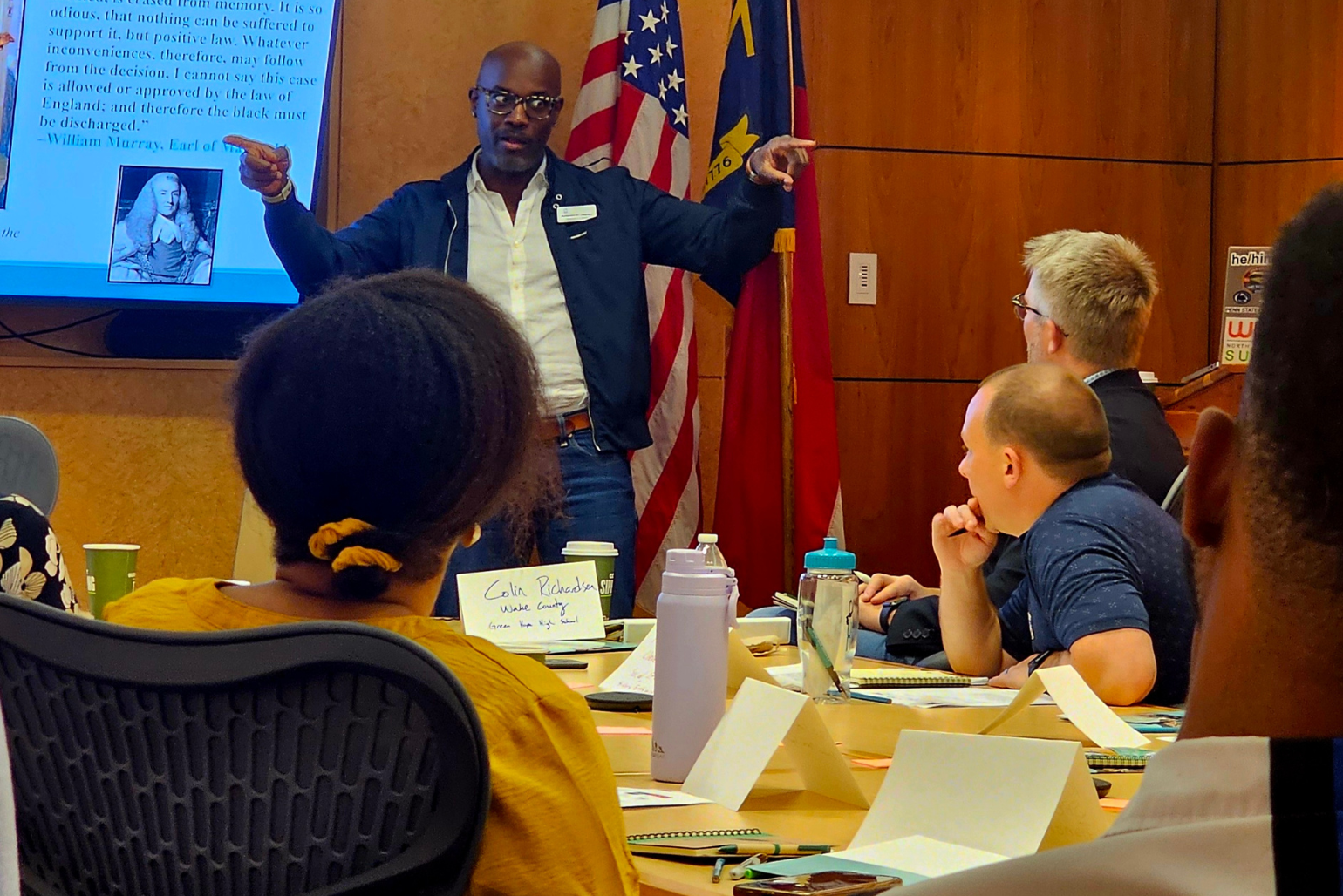Teachers listen to a speaker.