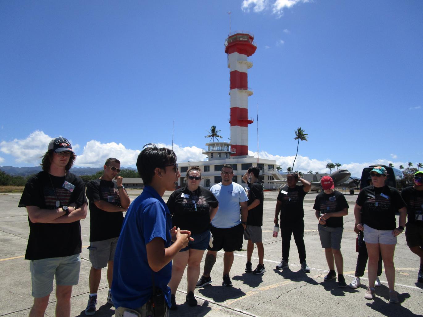 The tour group on the tarmac outside the Pearl Harbor Aviation Museum, hearing about what happened there during the attack on Pearl Harbor.