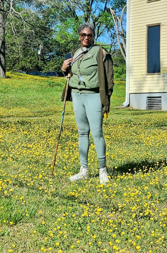 Valencia Abbott stands in a field of flowers at Historic Halifax