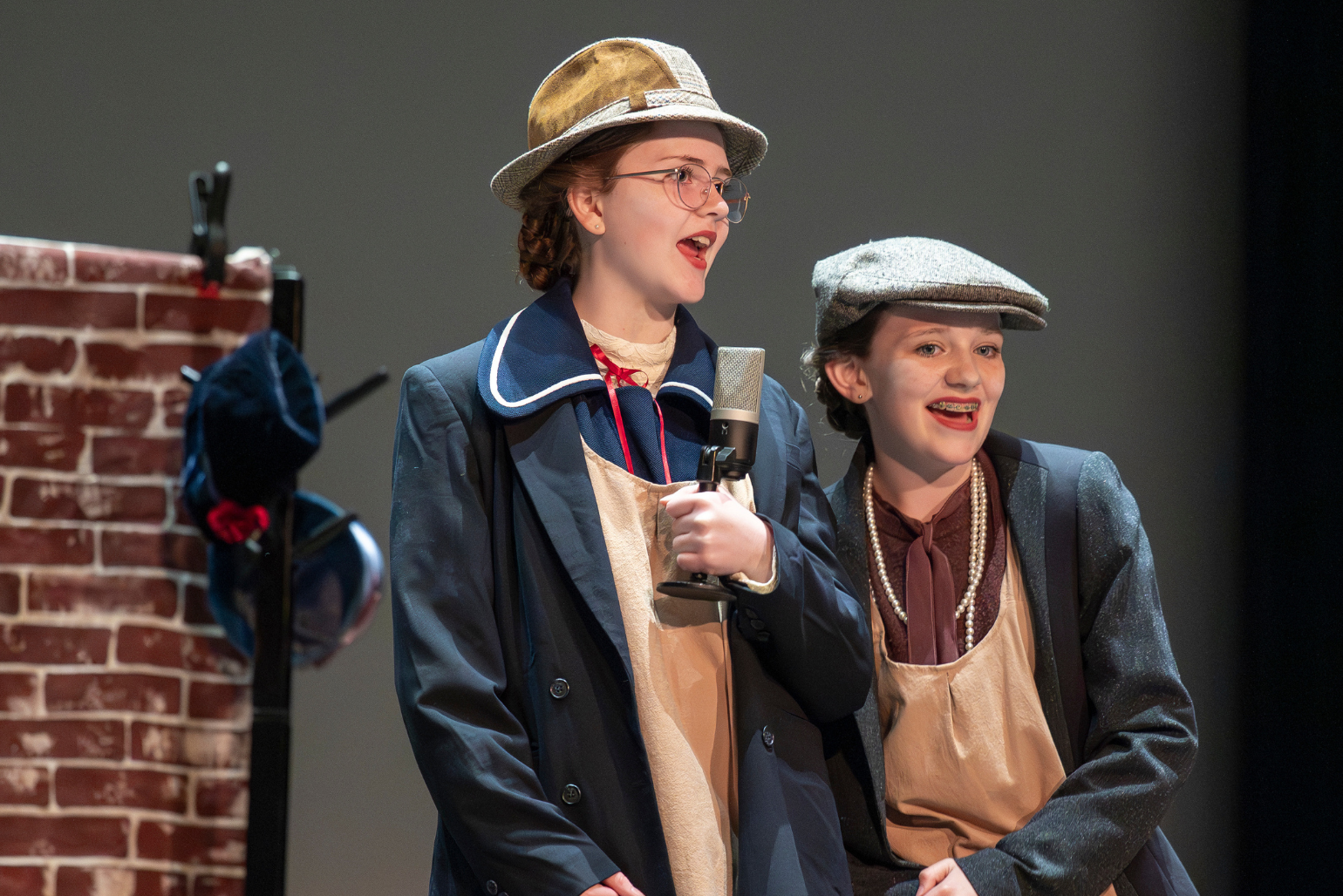 Two students perform on stage.