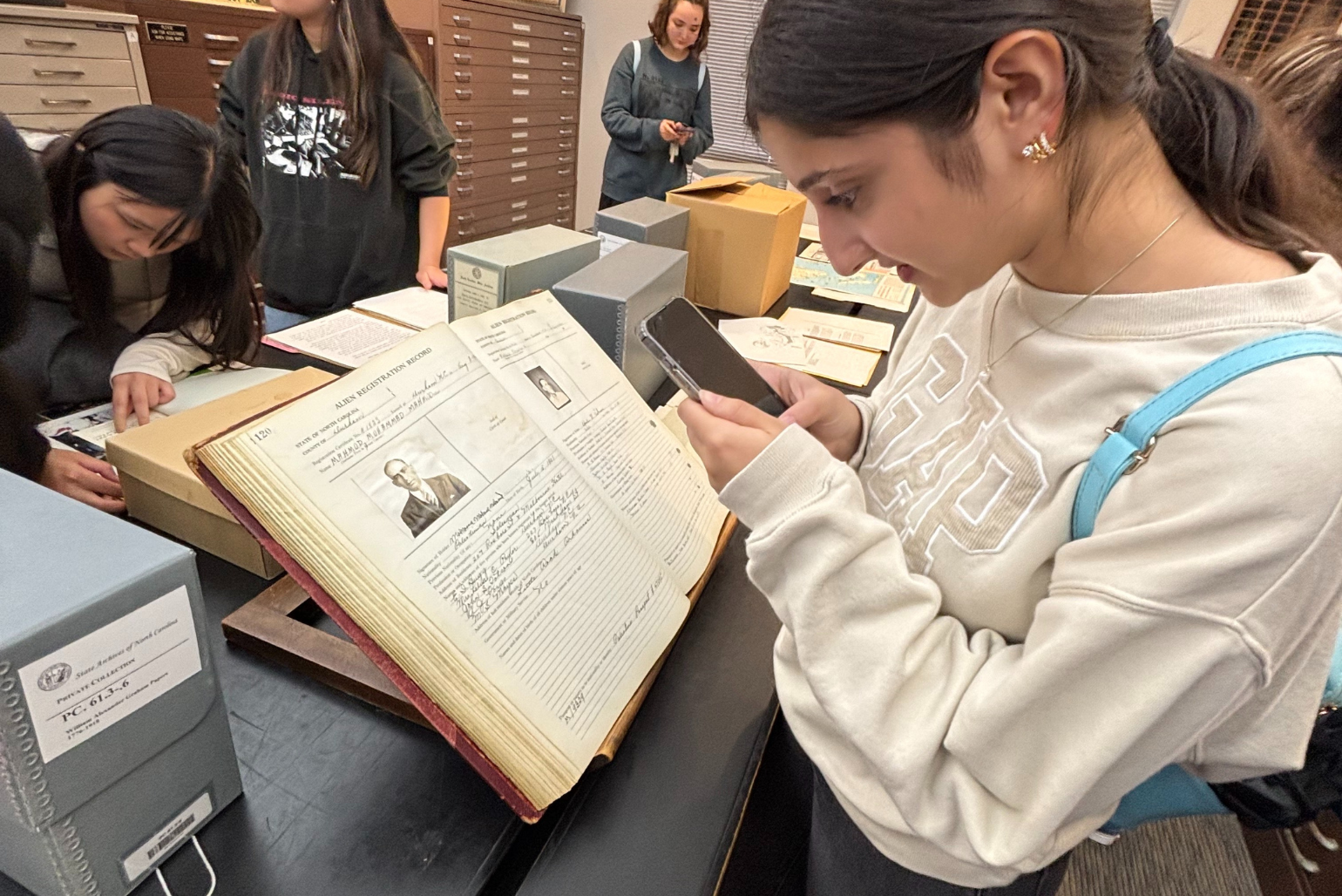 A student looks at historic immigration documents in the State Archives