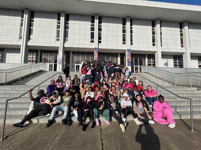 Students sit on the steps of DNCR
