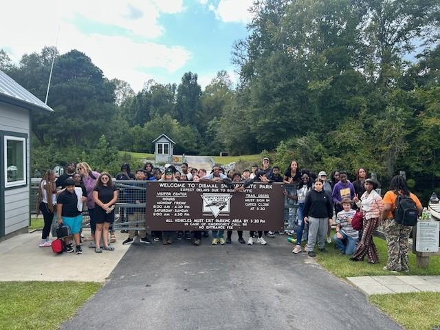 Students gather at the Dismal Swamp State Park Sign