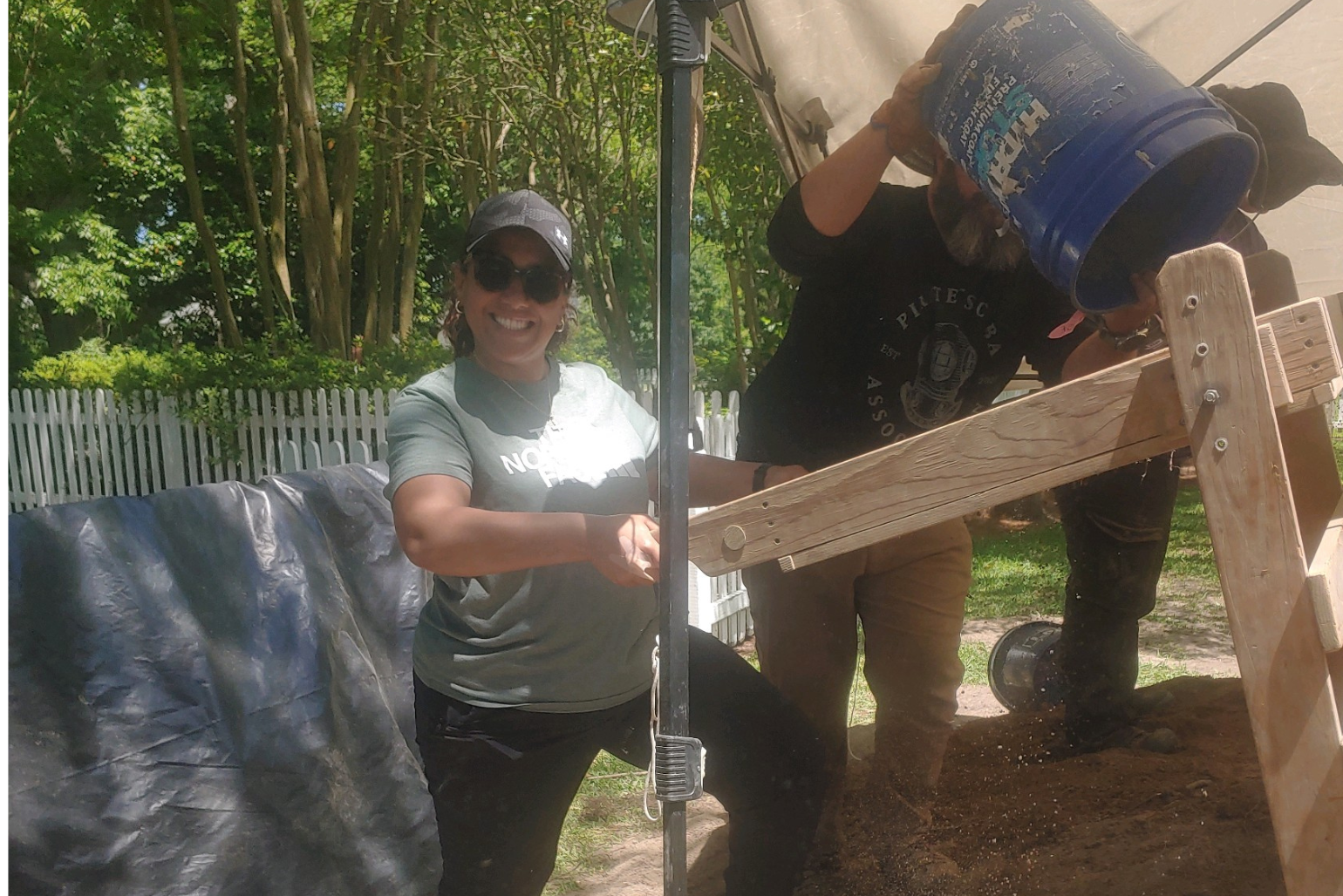 Simonae Williams uses a sifting screen during an archaeological dig at a DNCR site.