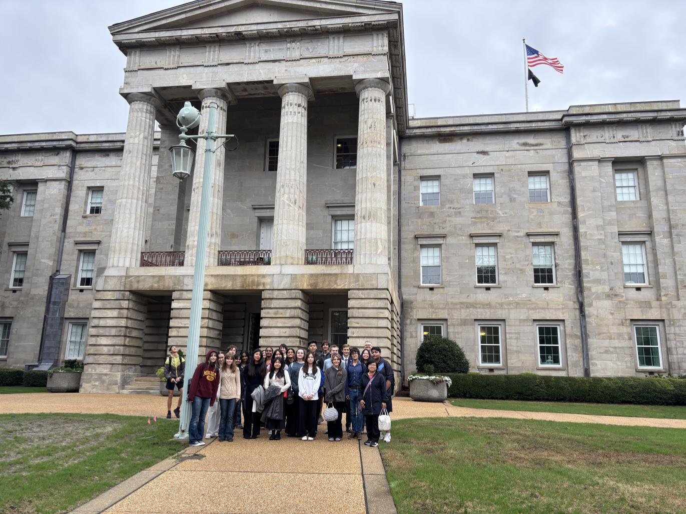 Student stand at the front of the NC State Capitol