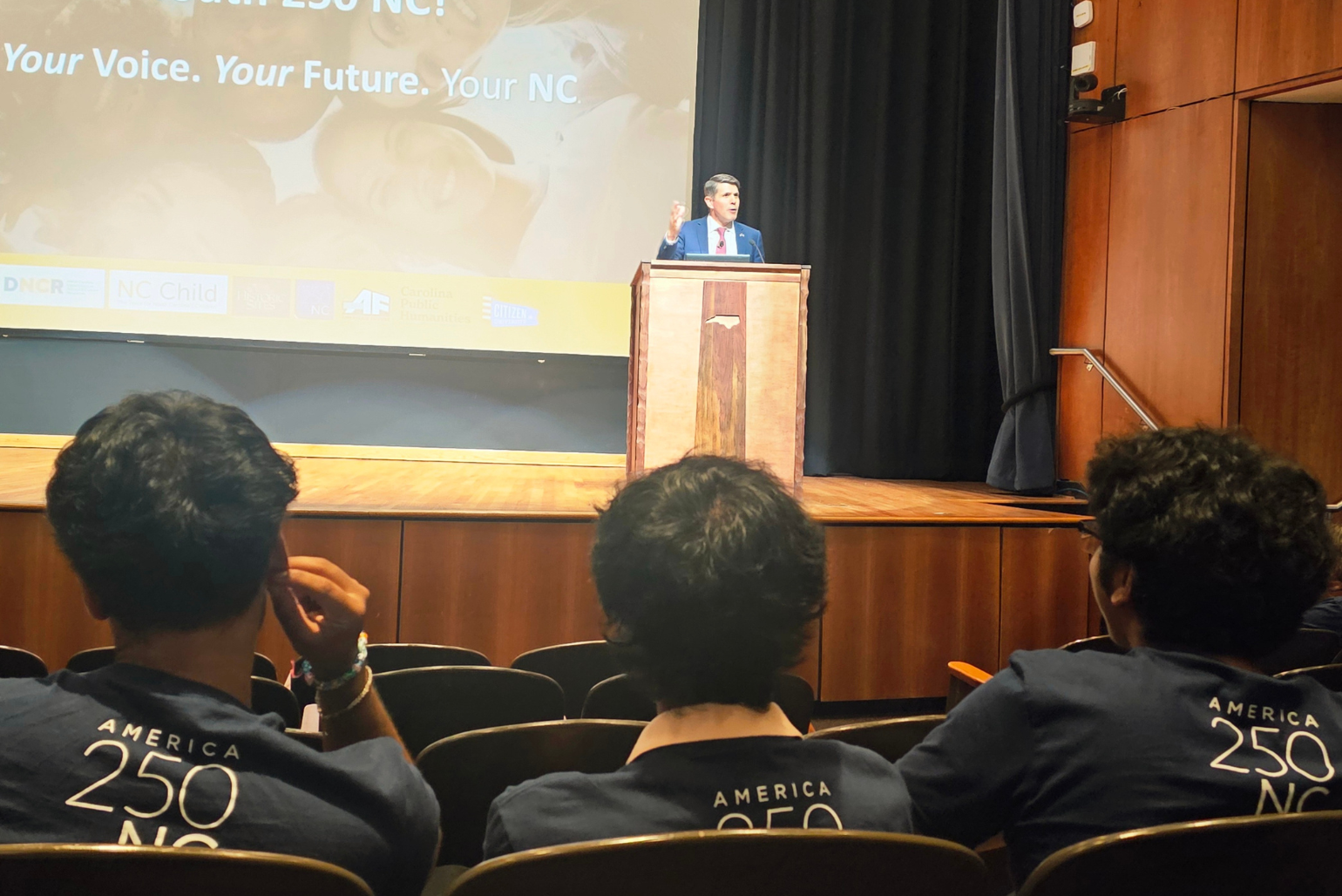 Students listen to a speaker at the kick-off to the day.